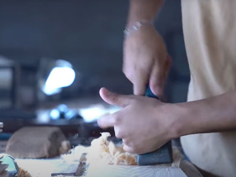 Worker shaving hardwood floors
