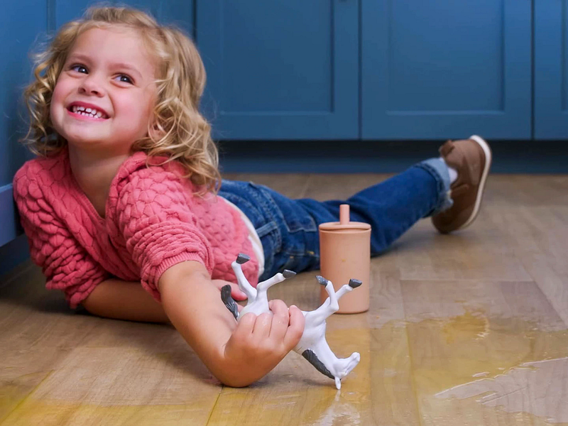 COREtec child playing on floor with spill